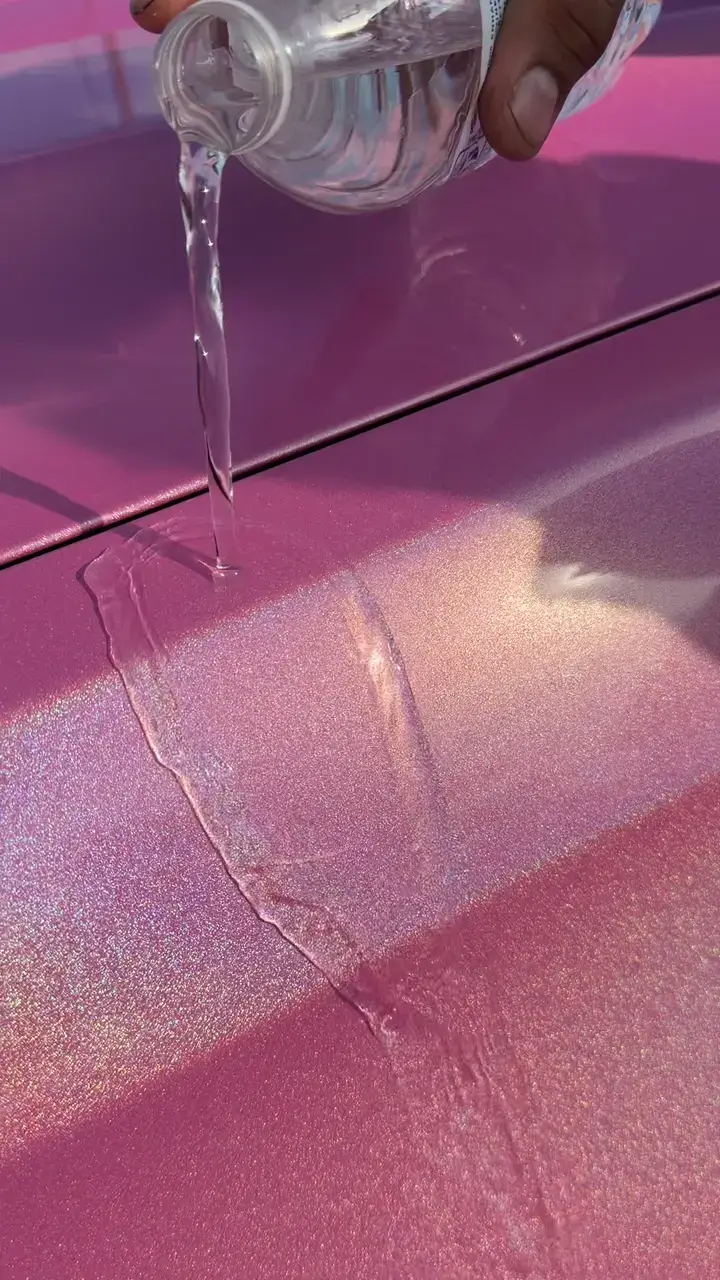 Water demonstration on the ceramic-coated pink GMC Sierra